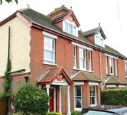 Edwardian red brick and partial partial painted  pebbledash semi detached house in Sussex with an interesting history