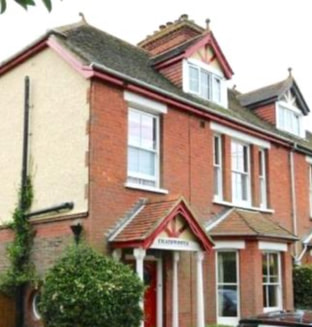 Edwardian red brick and partial partial painted  pebbledash semi detached house in Sussex with an interesting history