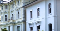 Close up of a row of white facade regency and Georgian houses 
